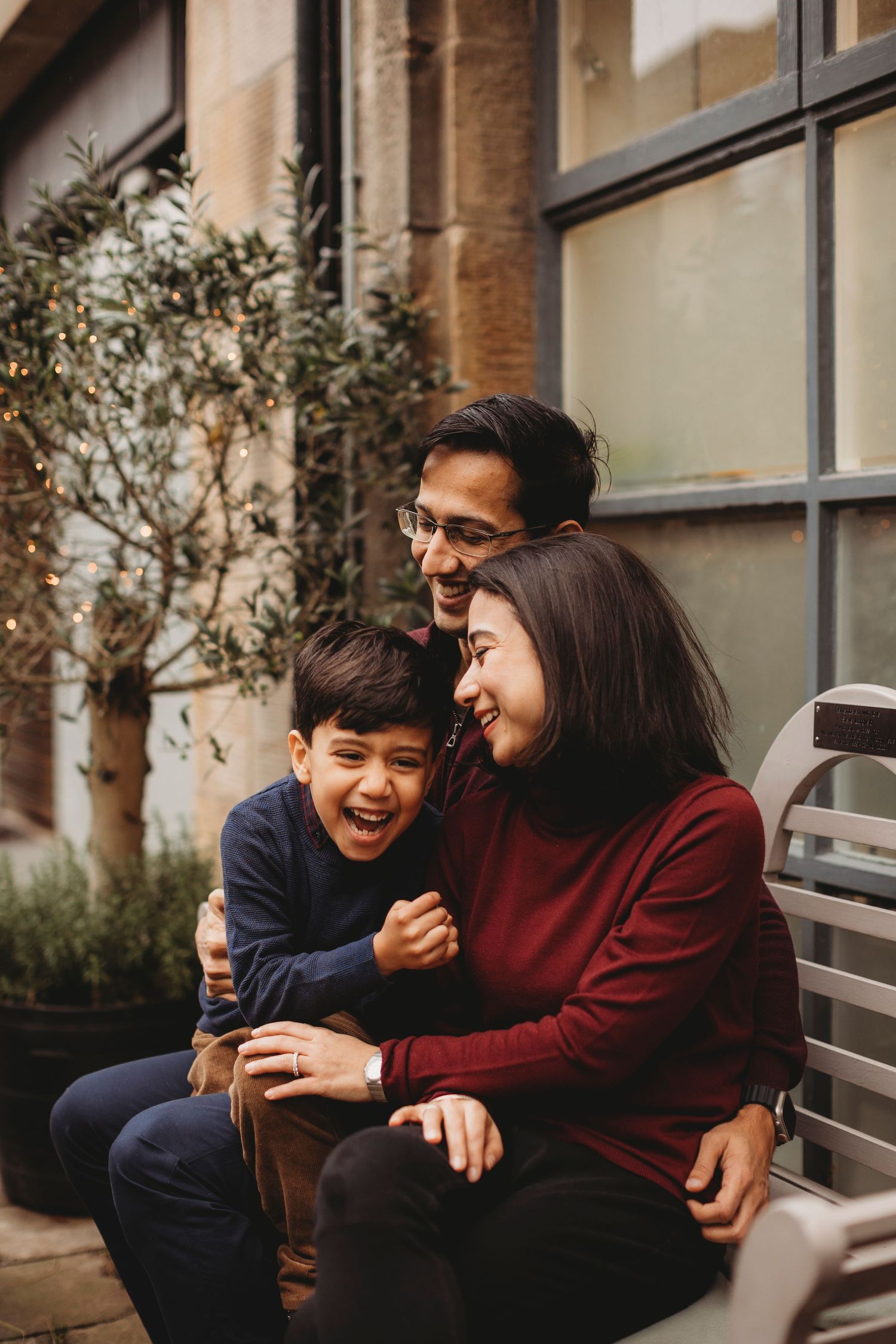 A heartwarming moment of shared laughter and joy on an outdoor bench.