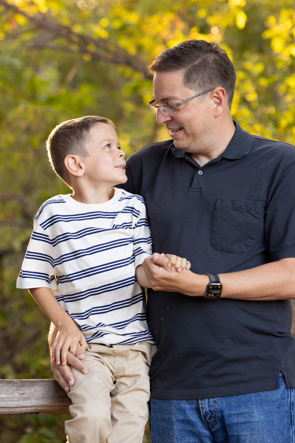 Young boy looks lovingly at his father at a family photoshoot in Vasona by Newborn and Family photographer Cindy Tucey