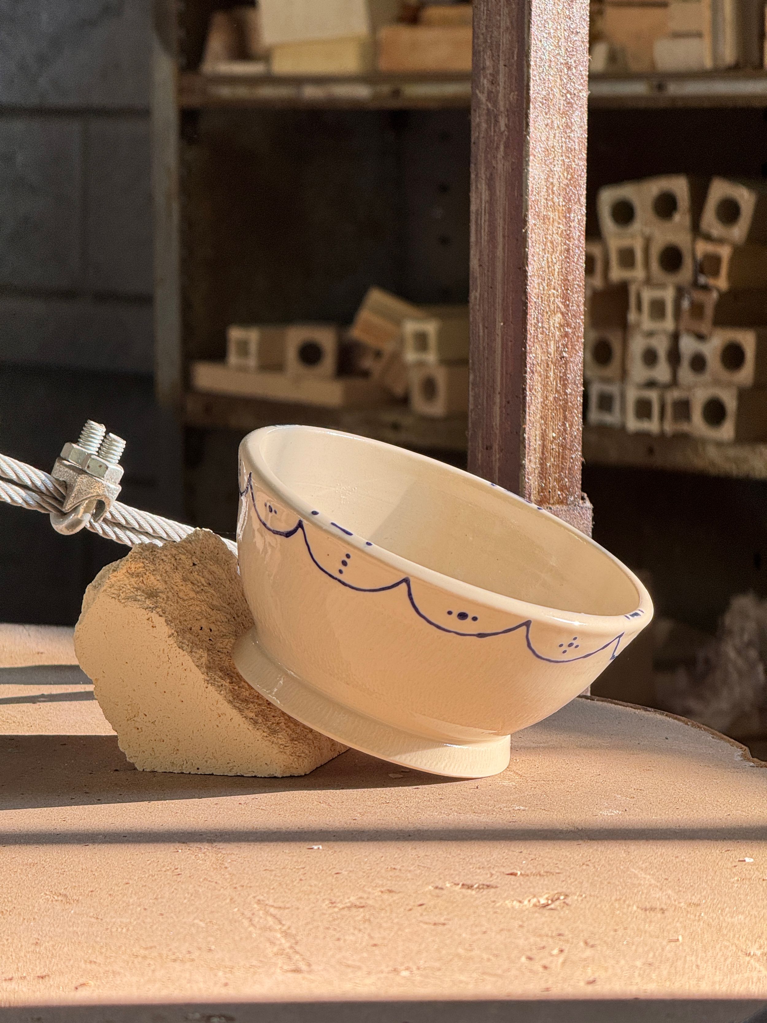 beige and blue handmade pottery bowl made at salmas pottery studios