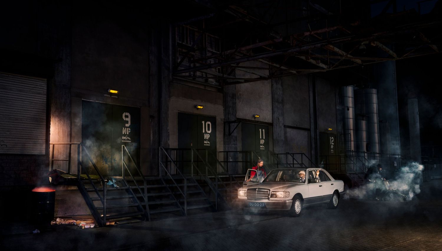 Nighttime urban street scene with atmospheric lighting and fog effects.