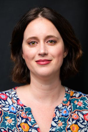 A person wearing a floral print top poses against a dark background in a series of similar headshots.