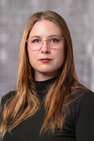 A series of five close-up portraits showing different angles of someone with auburn hair wearing a black turtleneck sweater.