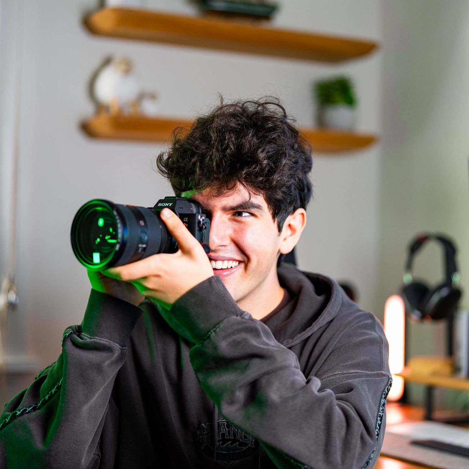 Photograph of a young man holding a camera
