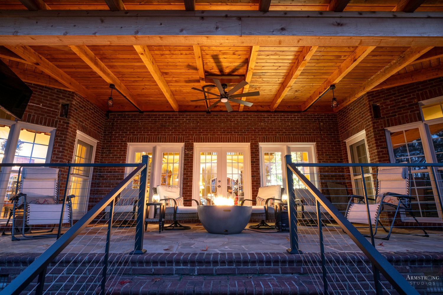 Wooden beams and exposed rafters create a rustic architectural detail in a residential ceiling interior.