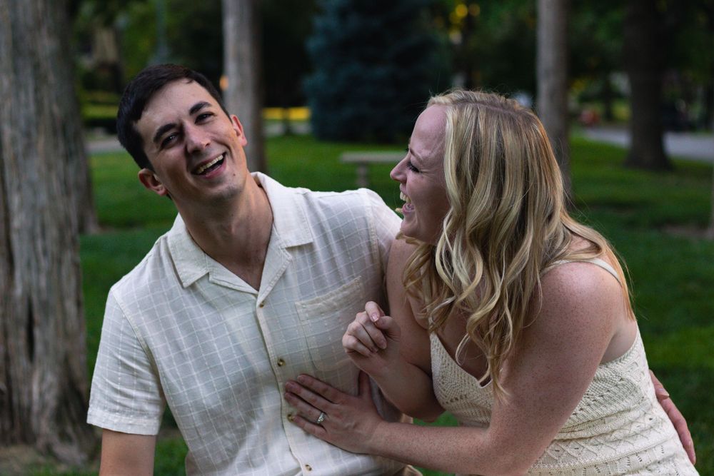 A couple shares a laugh together on a summer evening.