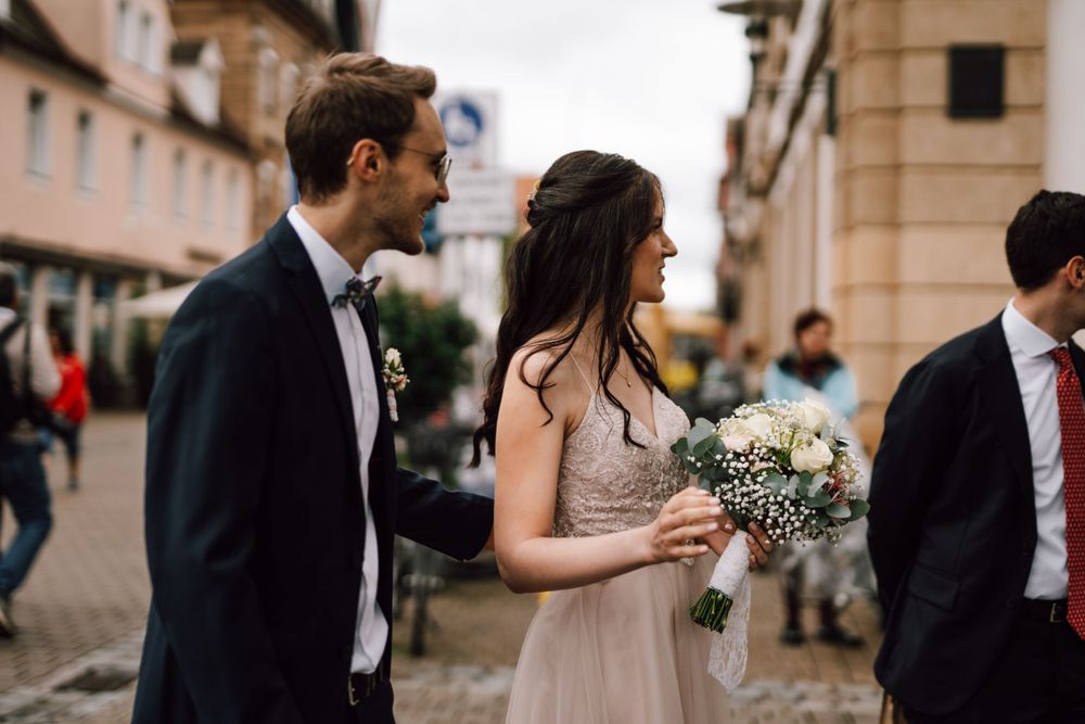 Couple shares a tender moment during their wedding ceremony at an elegant venue.