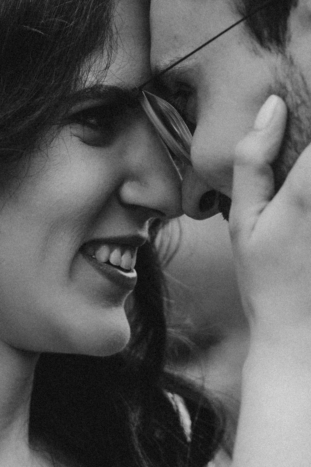 Close-up black and white shot of a tender moment between a couple.