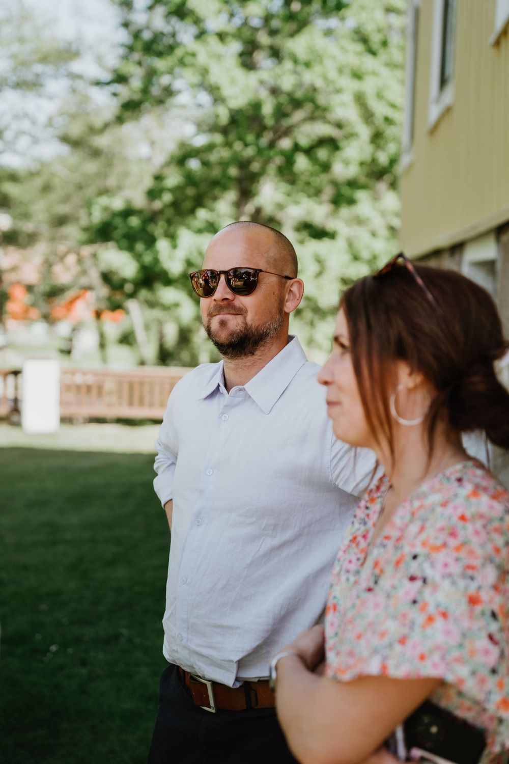Guests enjoying an outdoor wedding reception on a sunny summer day.