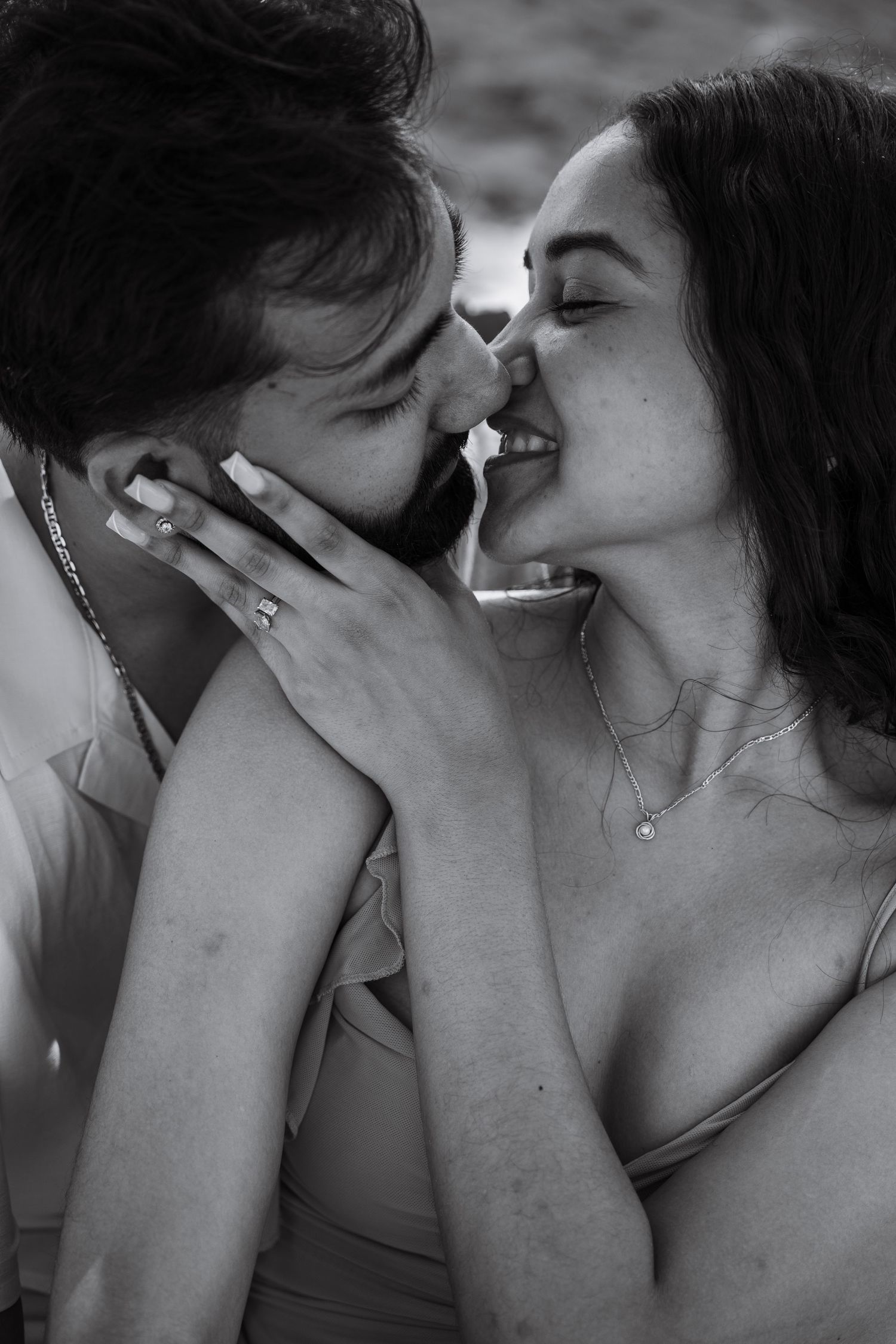 Intimate black and white portrait of romantic couple sharing a tender moment.