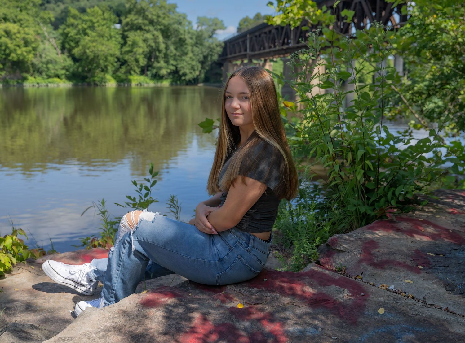 Sequence of relaxed portrait photos showing someone lying on autumn leaves in nature.