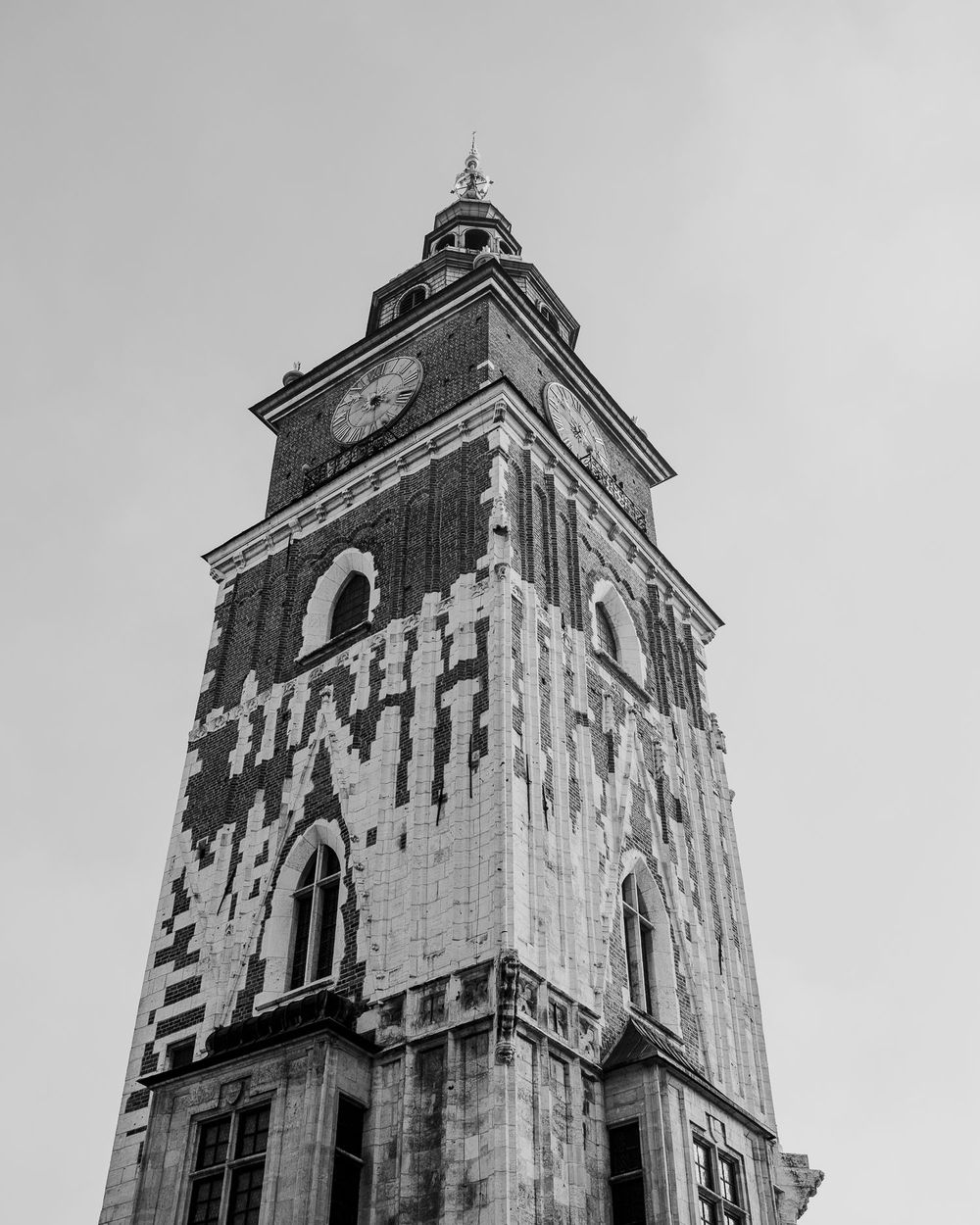 Historic church tower with ornate architectural details and clock face shown from multiple angles in black and white.