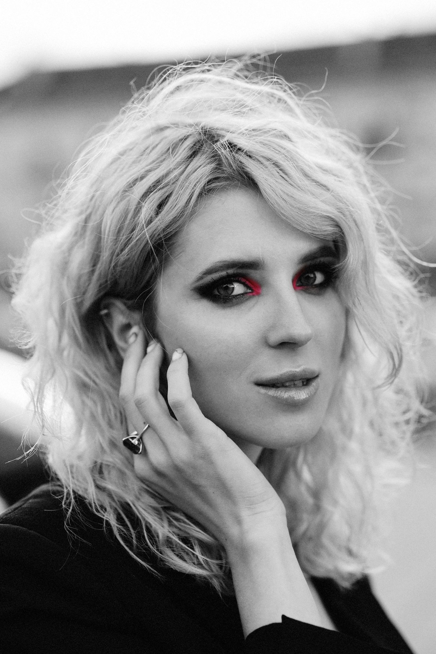 close-up portrait of model with  smokey eyes makeup in Vilnius. Pink eye shadow. Ring on the hand