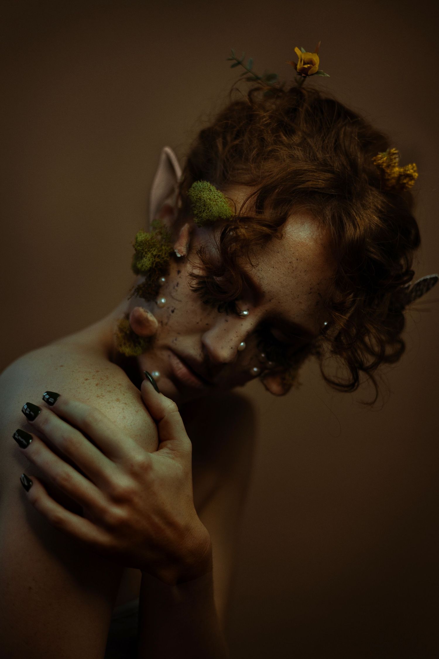 A self-portrait of Danielle Ariadne, Boston's best creative portrait photographer, with orange and yellow eye makeup and monarch butterflies
