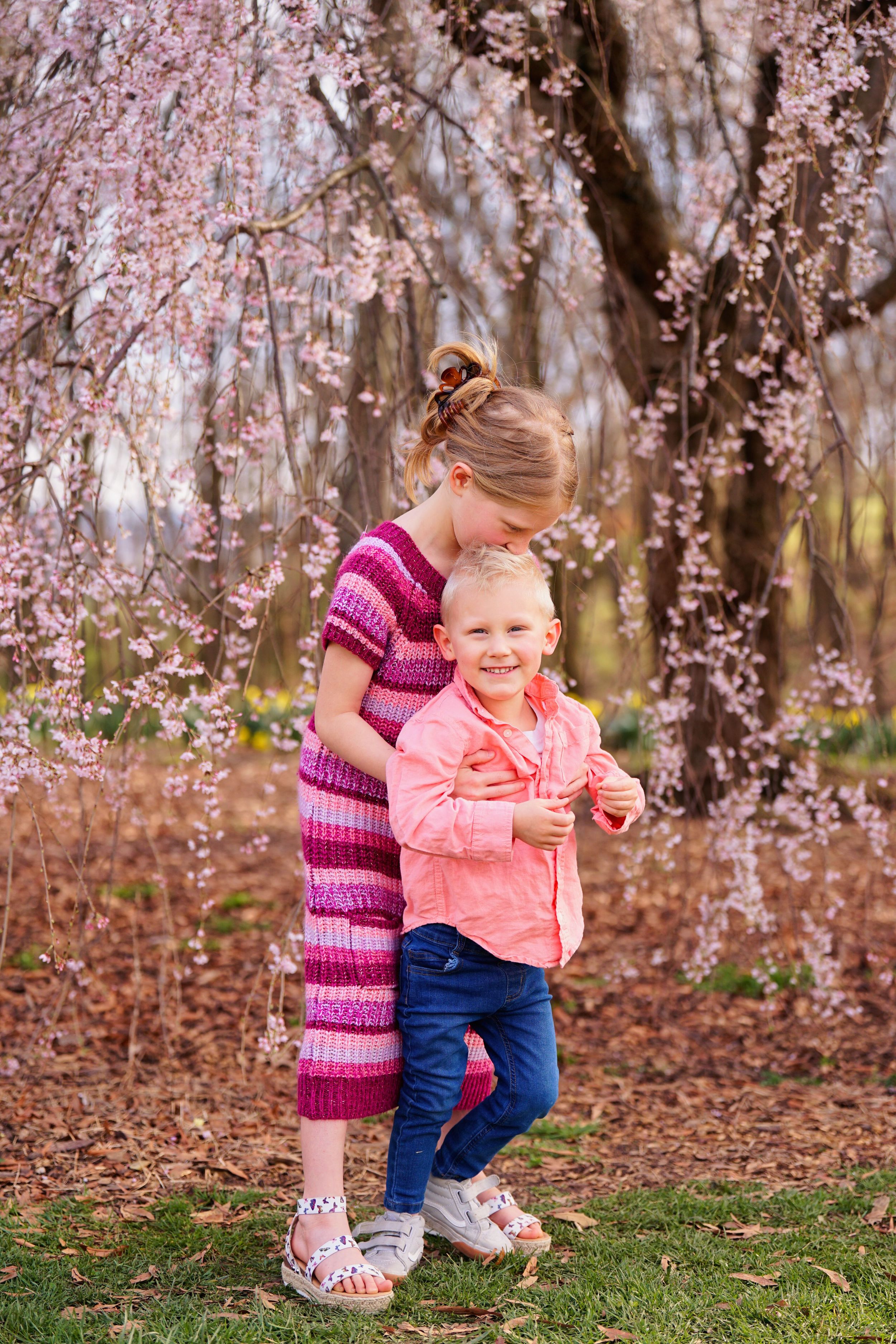 Chelsea and Cody getting family portraits with their kids at Ault Park in Cincinnati Ohio with the cherry blossoms