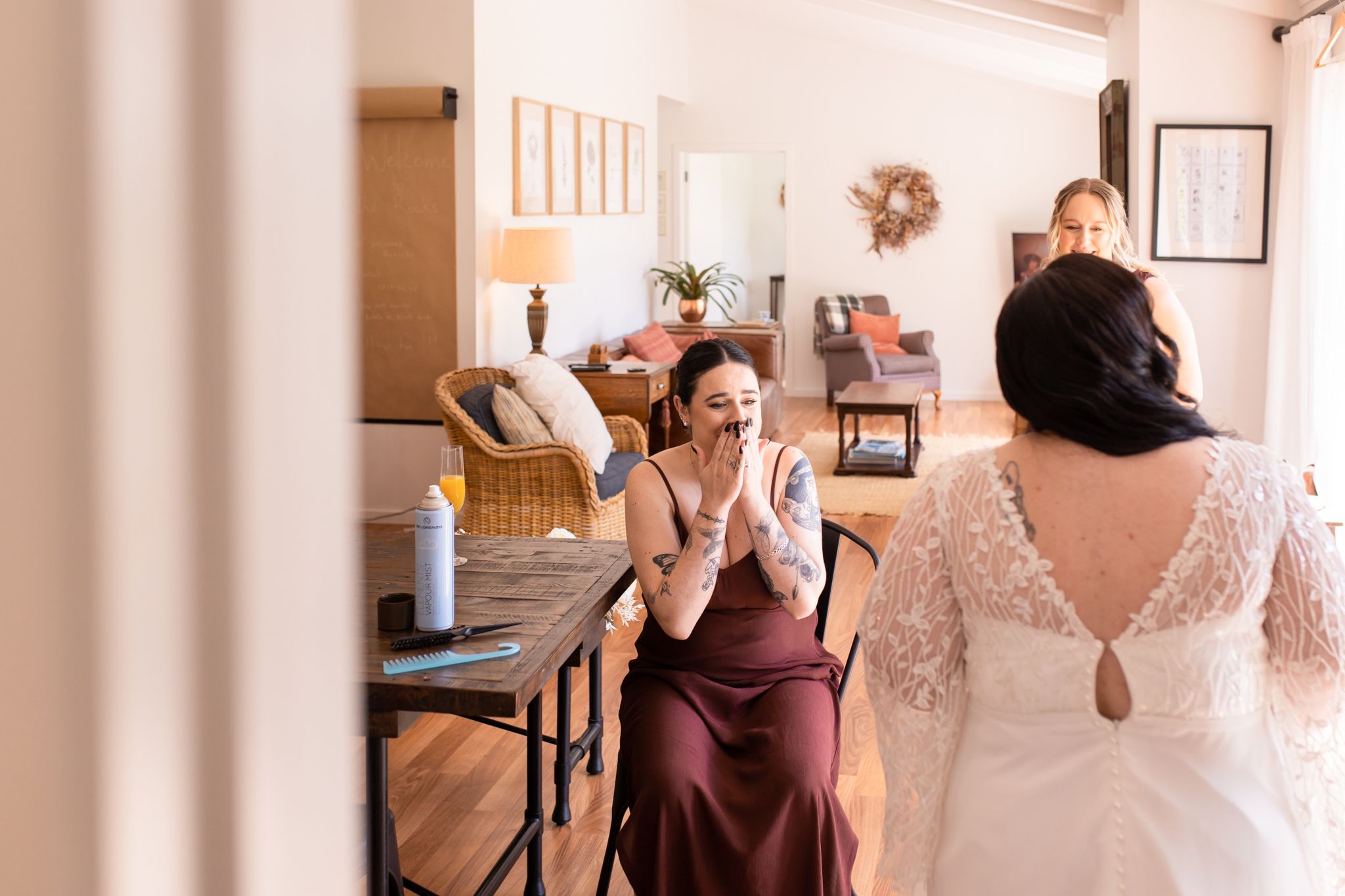 Wedding party getting ready in an intimate indoor setting with natural light.