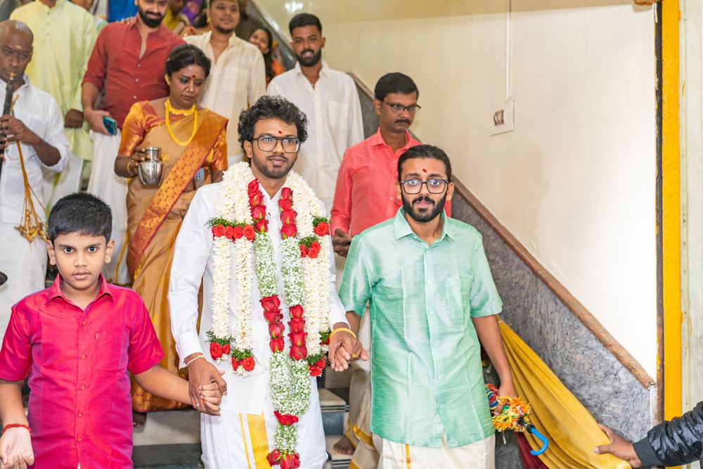 People in traditional Indian attire walking down decorated stairs during a celebration.