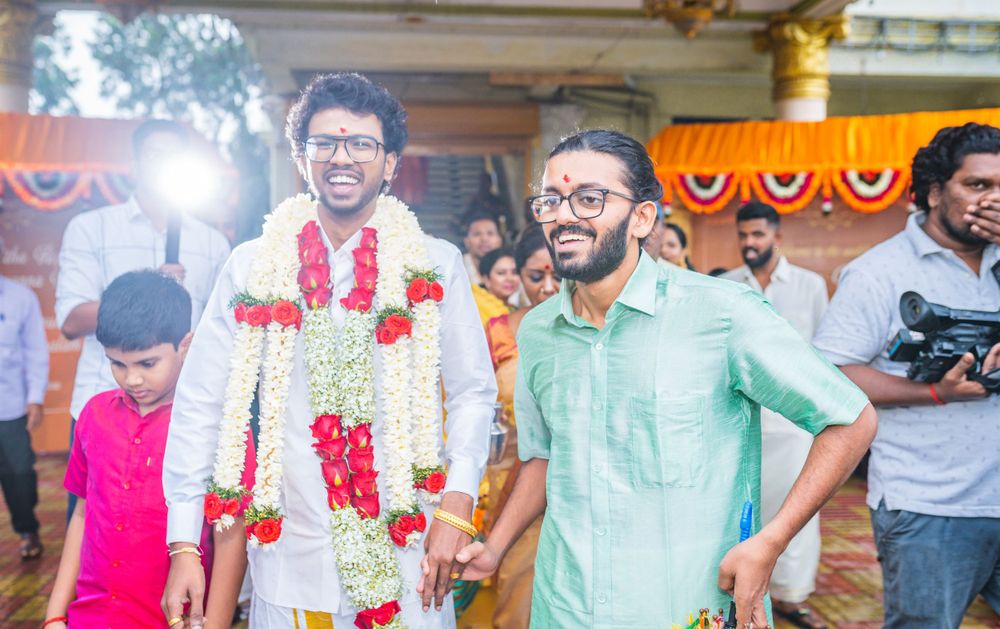 Celebratory gathering with people dressed in festive attire and floral decorations.