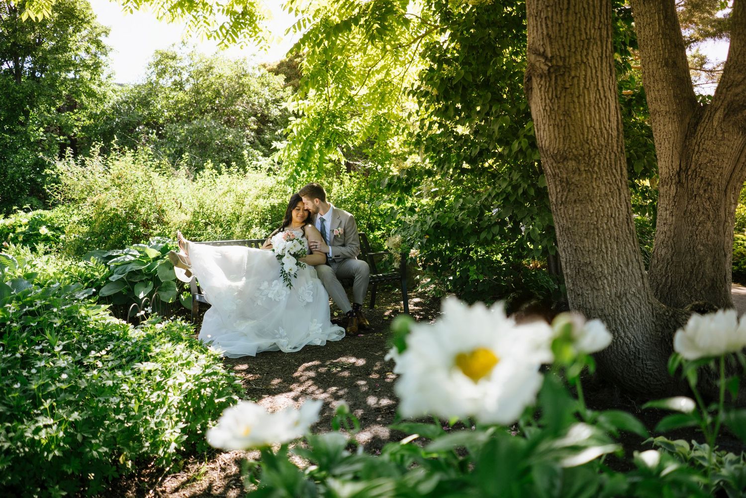 A scenic mountain wedding photo with fall foliage, a river, and peaks in the background.