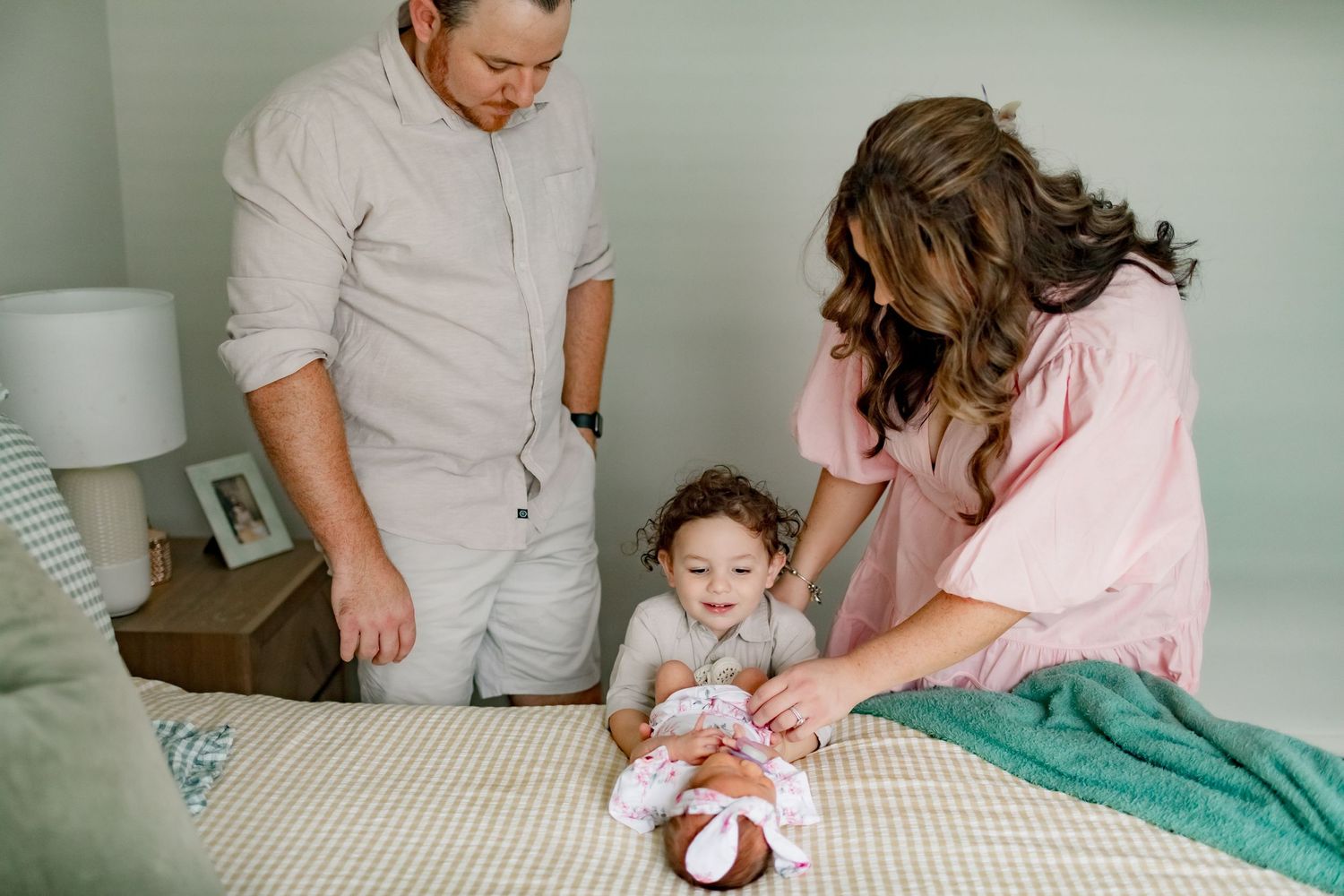 A family gathering on a bed sharing a special moment together.