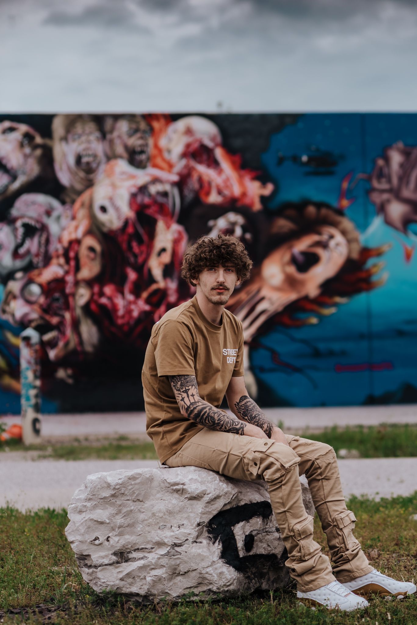 Senior boy in front of graffiti wall