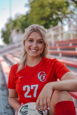 Soccer player holding a ball in the bleachers