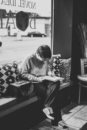 senior girl drawing in a coffee shop window