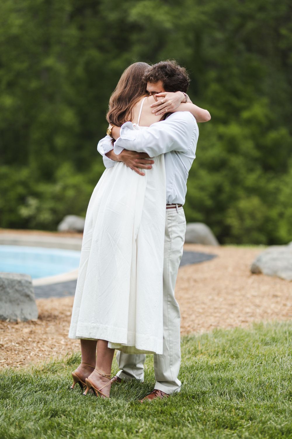 Young couple wearing white getting married outside