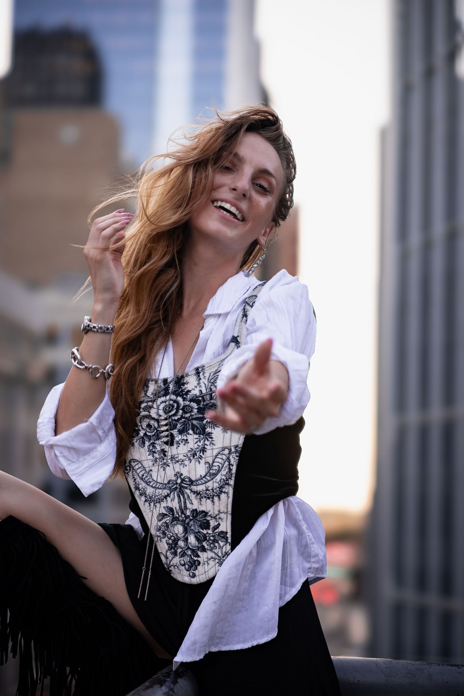 Dynamic fashion portraits showing movement and emotion against an urban cityscape.