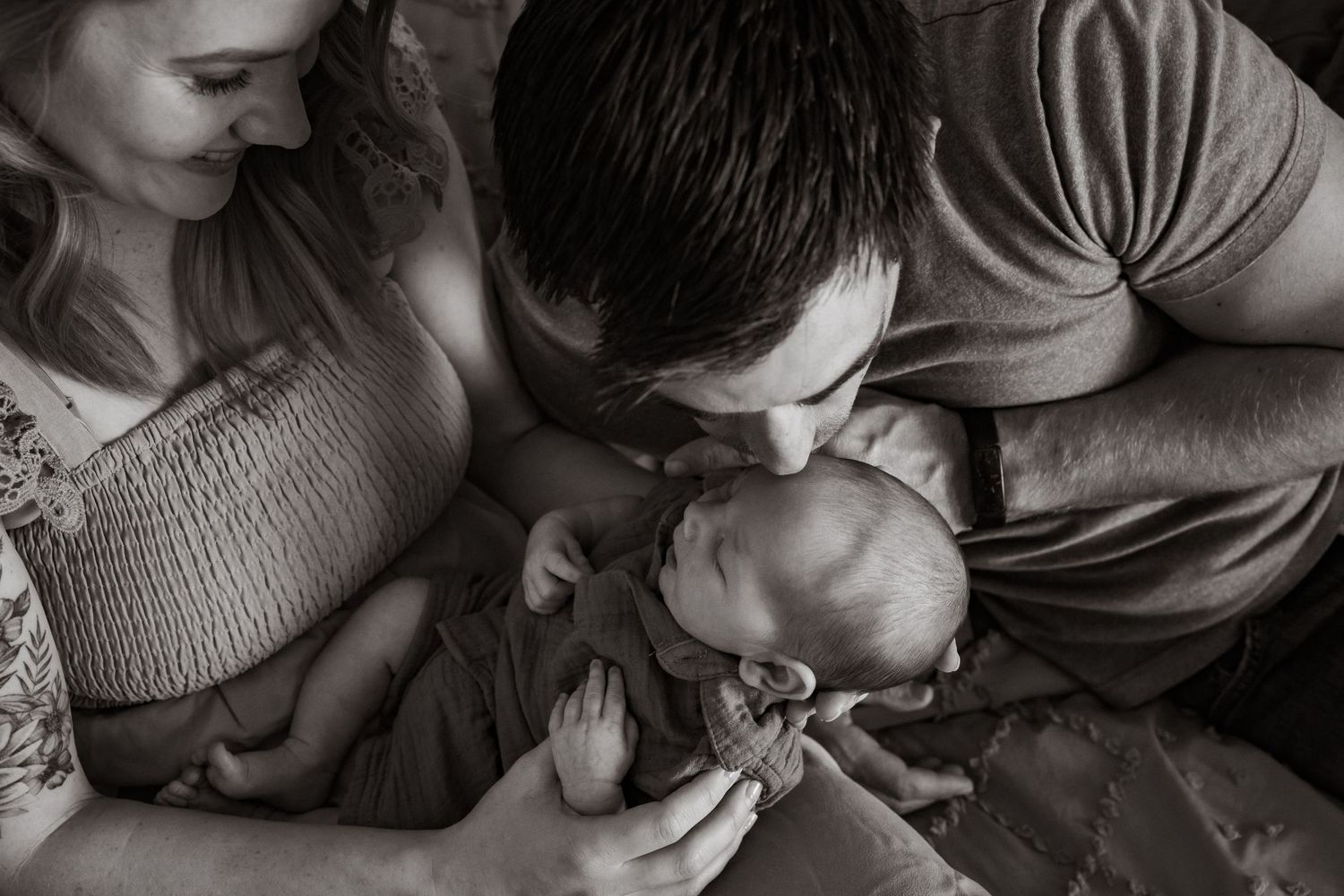 A series of black and white photographs showing intimate moments between parents and newborn babies.