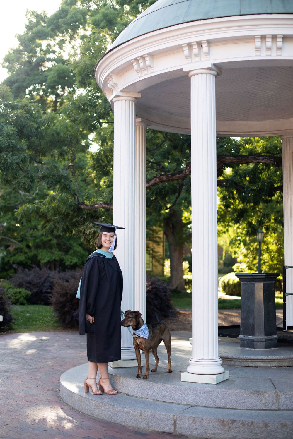 A series of photos showing a graduate and their dog posing in a classical white columned gazebo.