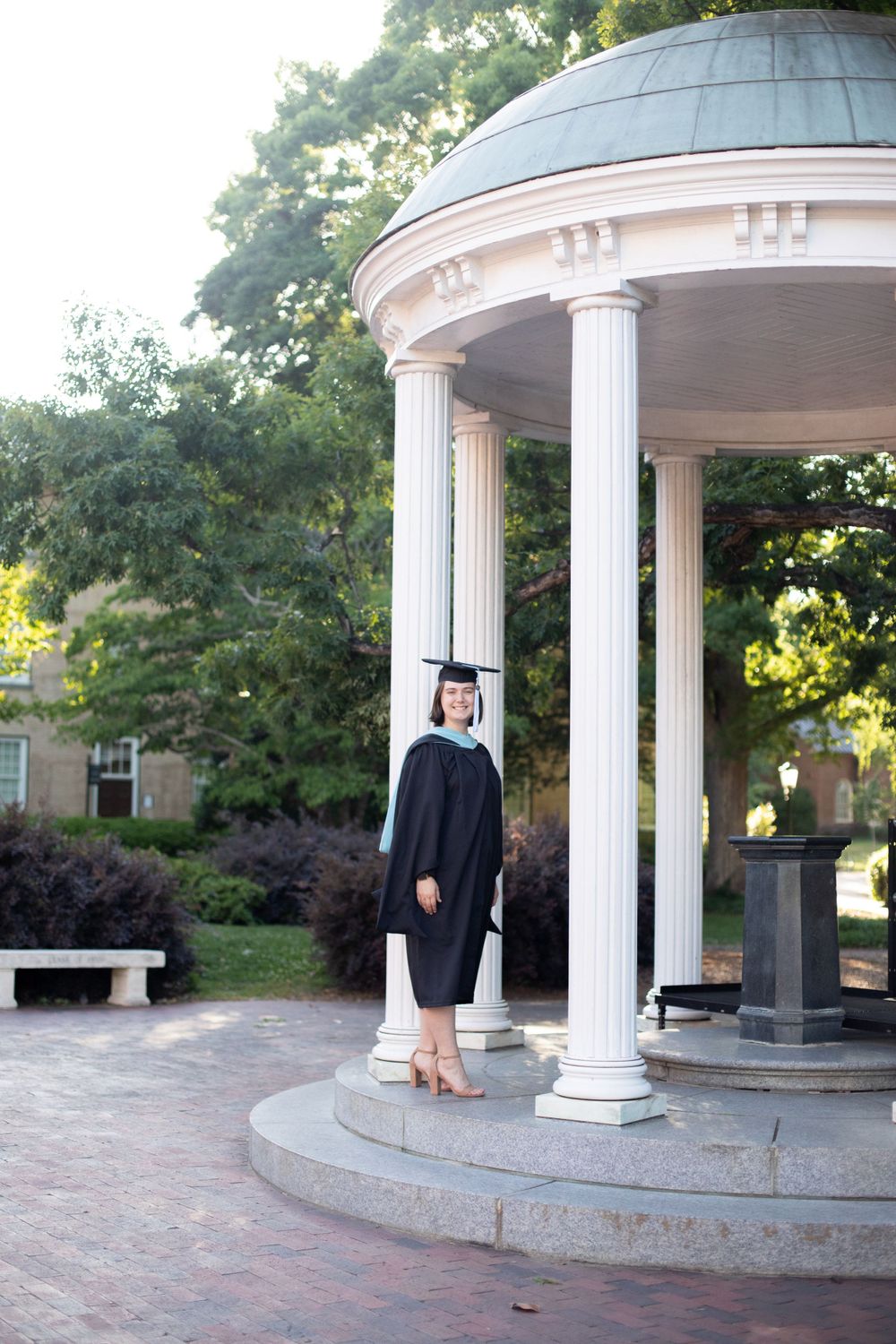 A sequence of graduation photos taken at a white columned pavilion in a garden setting.