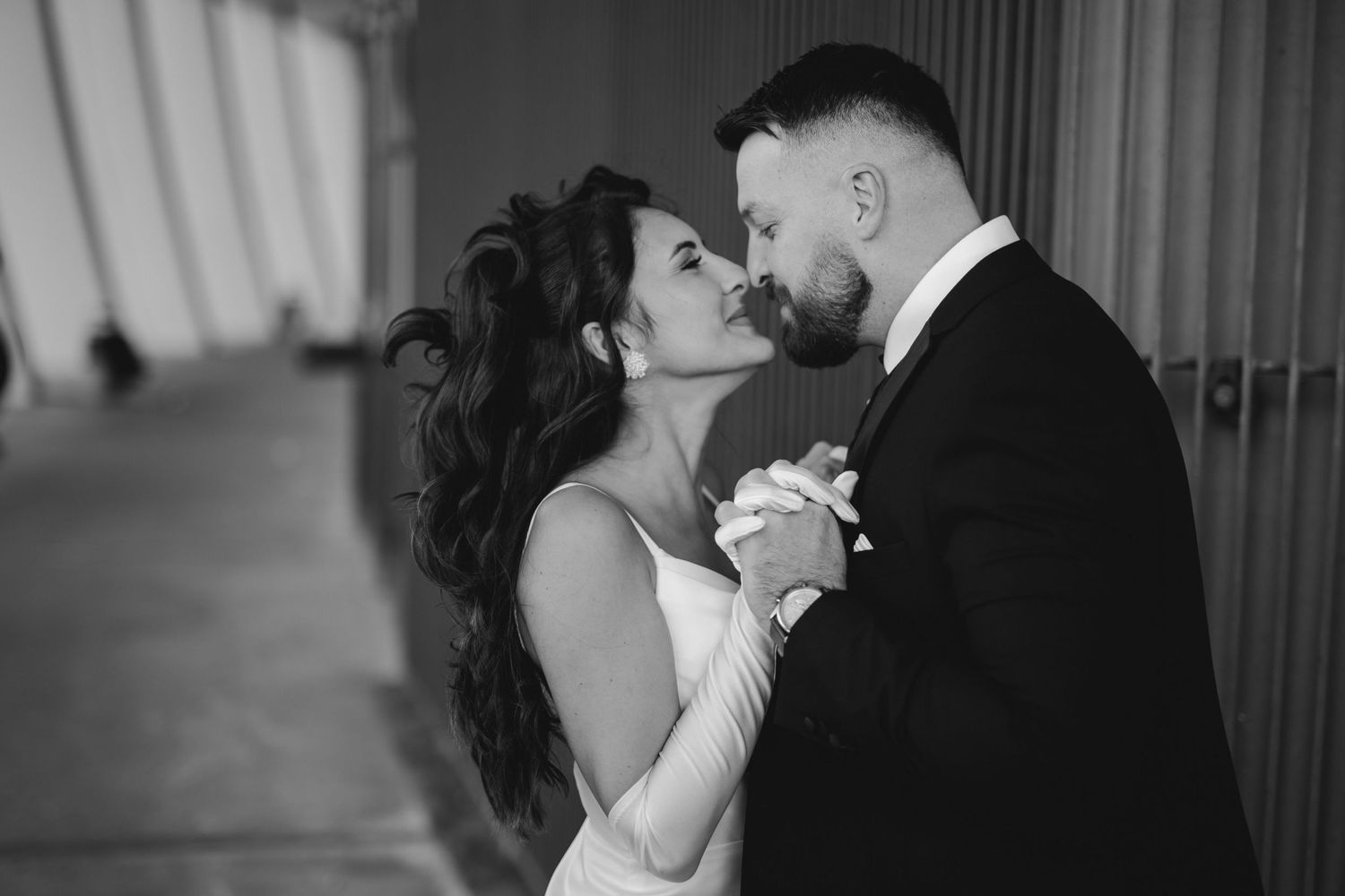 Black and white photo of a romantic dance moment between newlyweds during their wedding celebration.