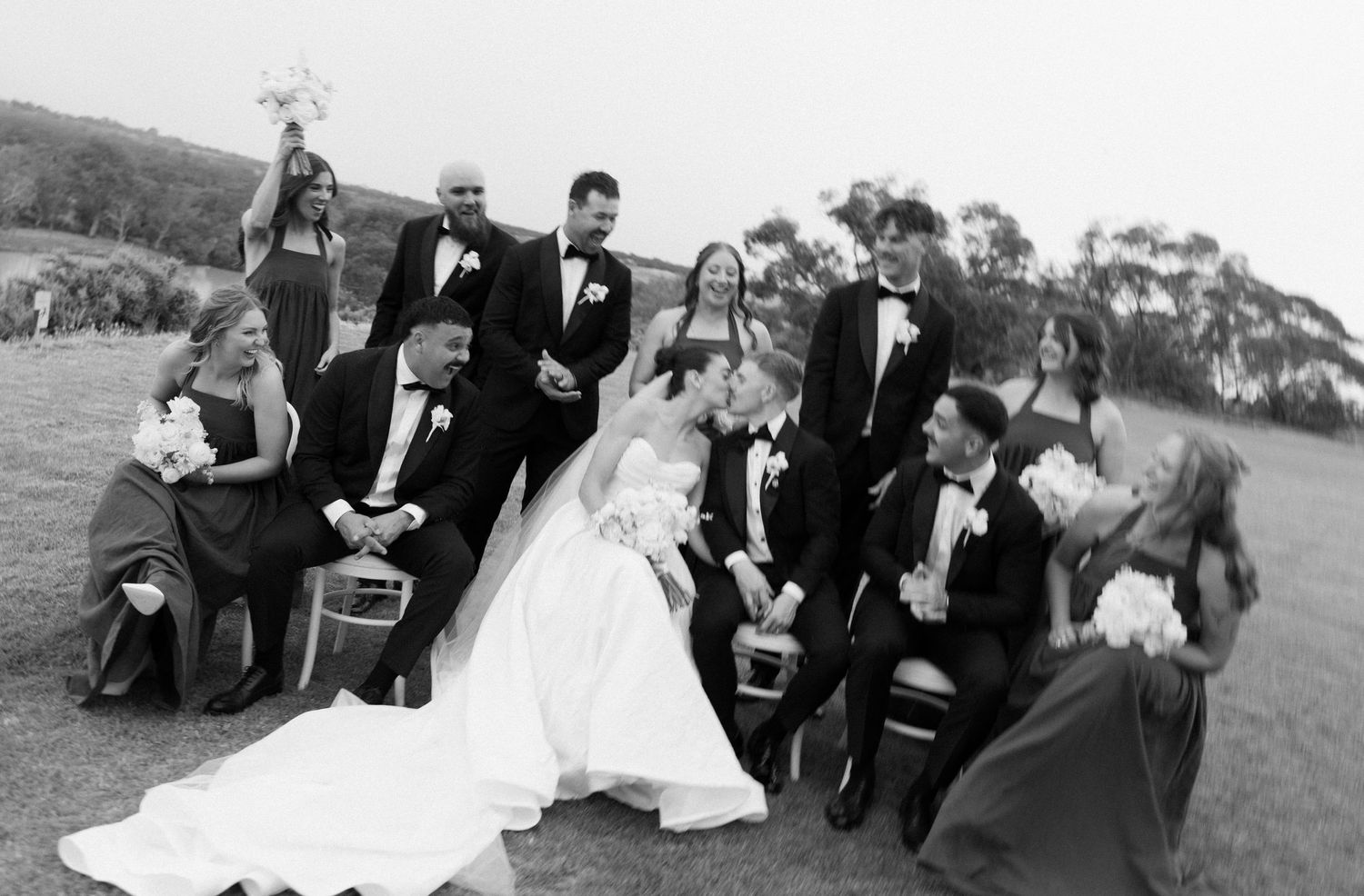 A series of black and white wedding photos showing romantic moments outdoors with mountains in the background.