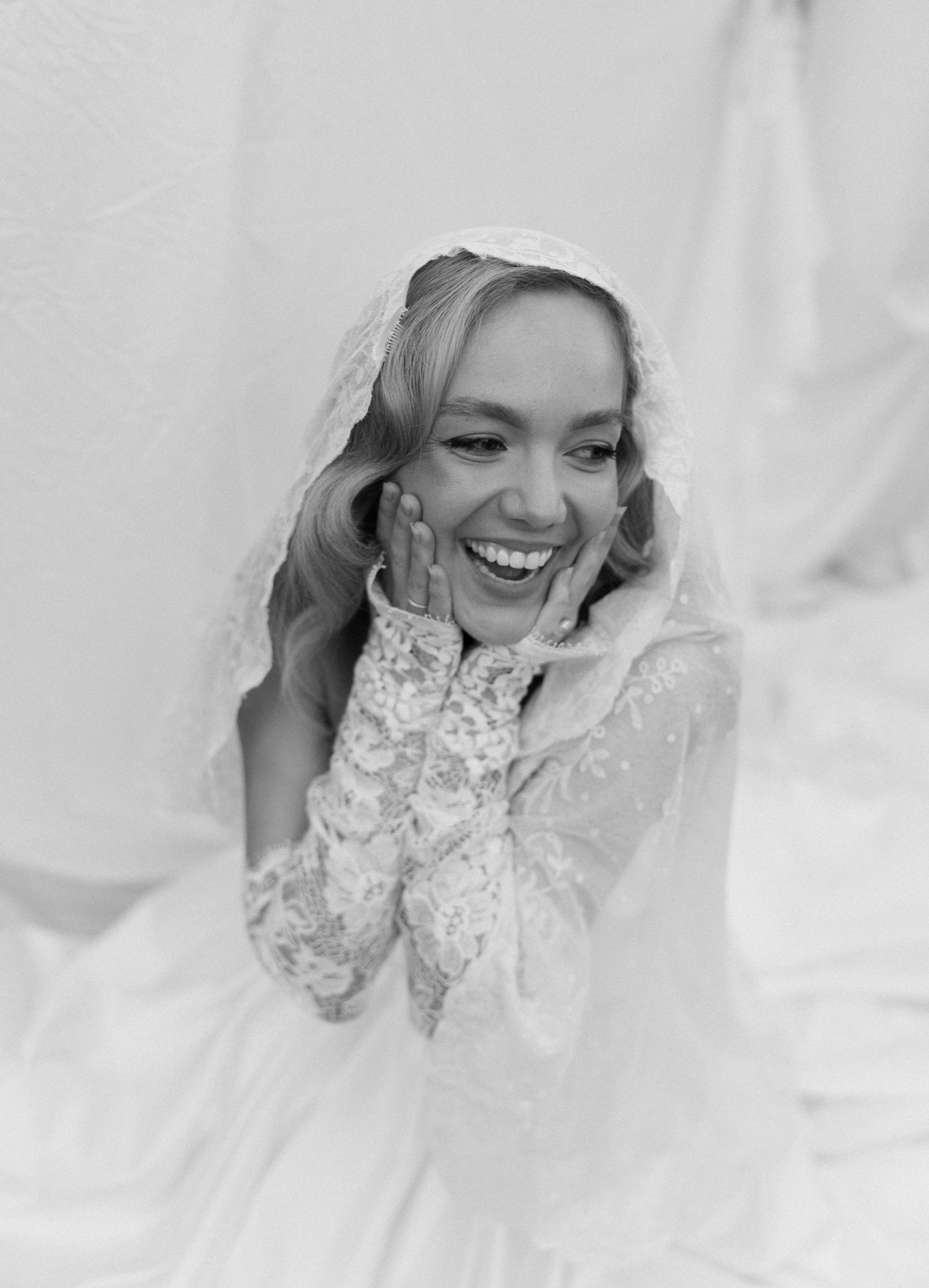 A black and white series of wedding photos showing a joyful bride in lace against a white background.