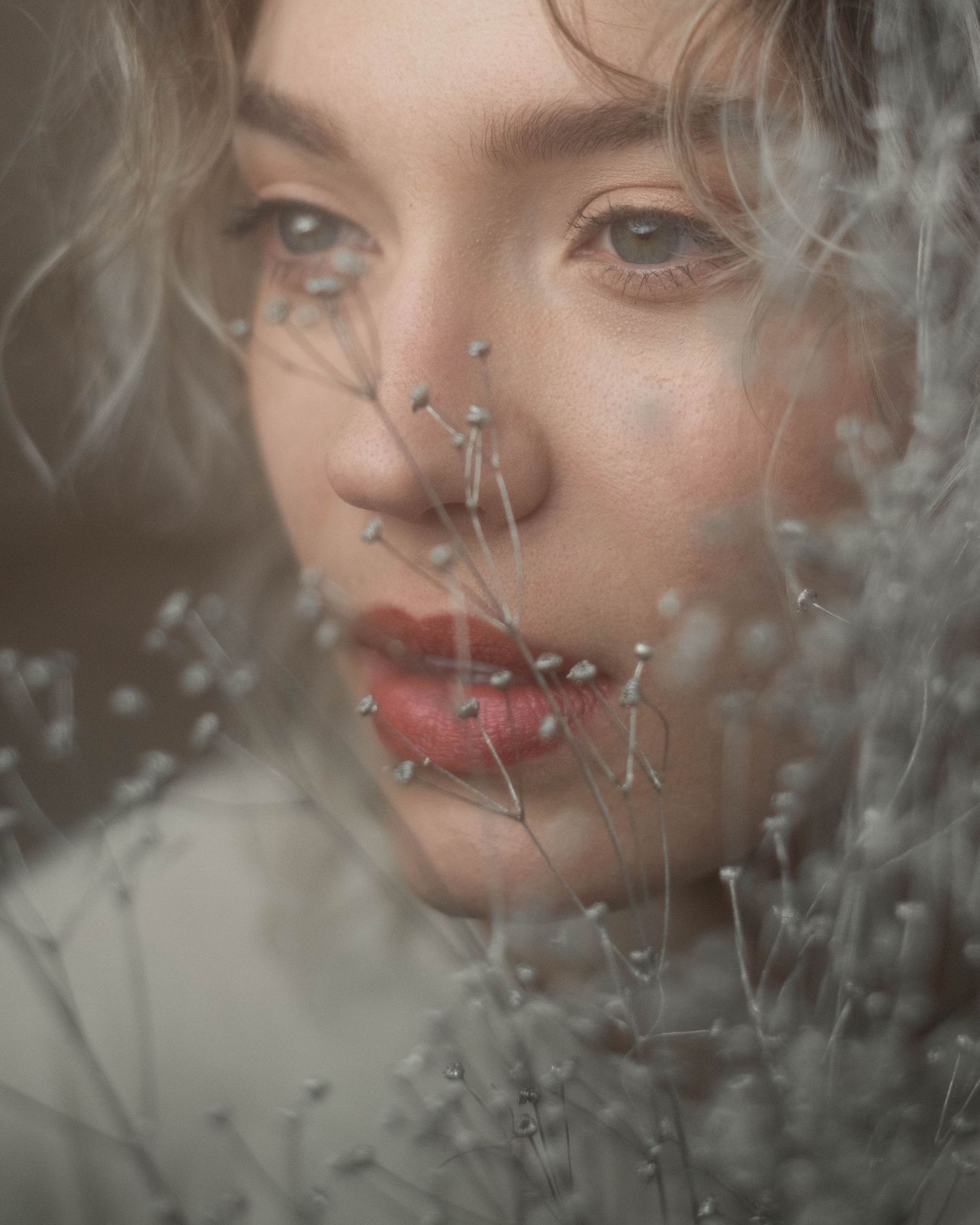 Artistic portrait through frosted glass creating a dreamy ethereal effect.