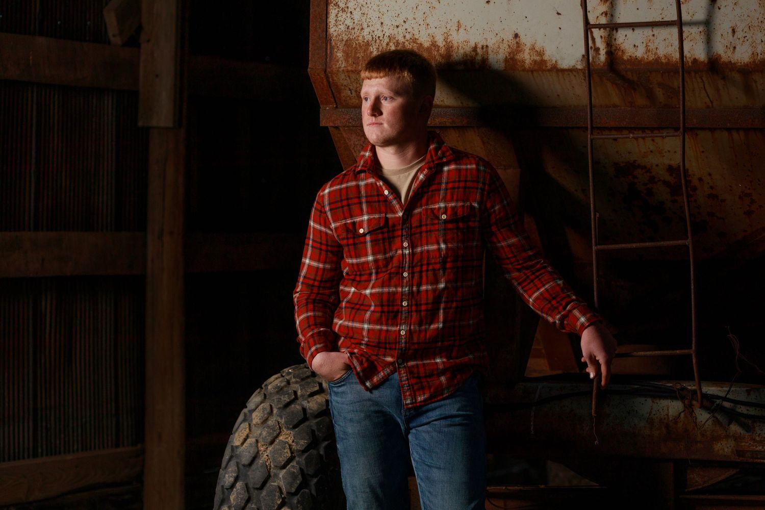 He wasn't born in a barn, but he sure poses in one really good. Boys high school senior pictures.