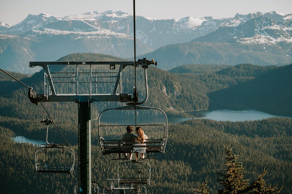 Couple sitting on Mt Washington chair lift Adventure session Vancouver Island. Photography by Photographer Soulfull Photographs