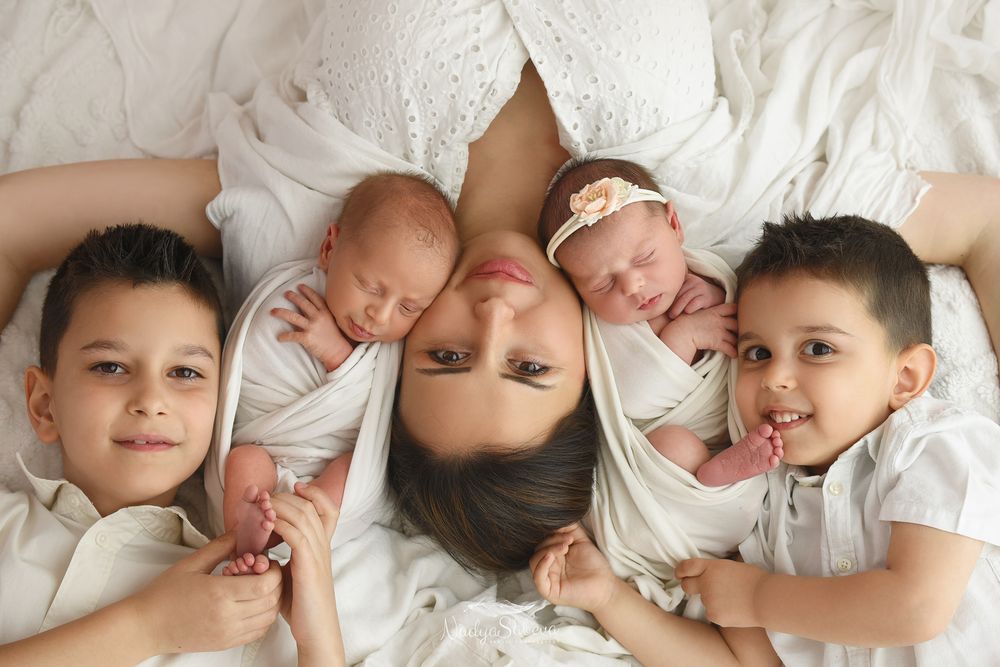 A collection of tender moments showing a baby's first month milestones, captured in a series of white apparel photos.