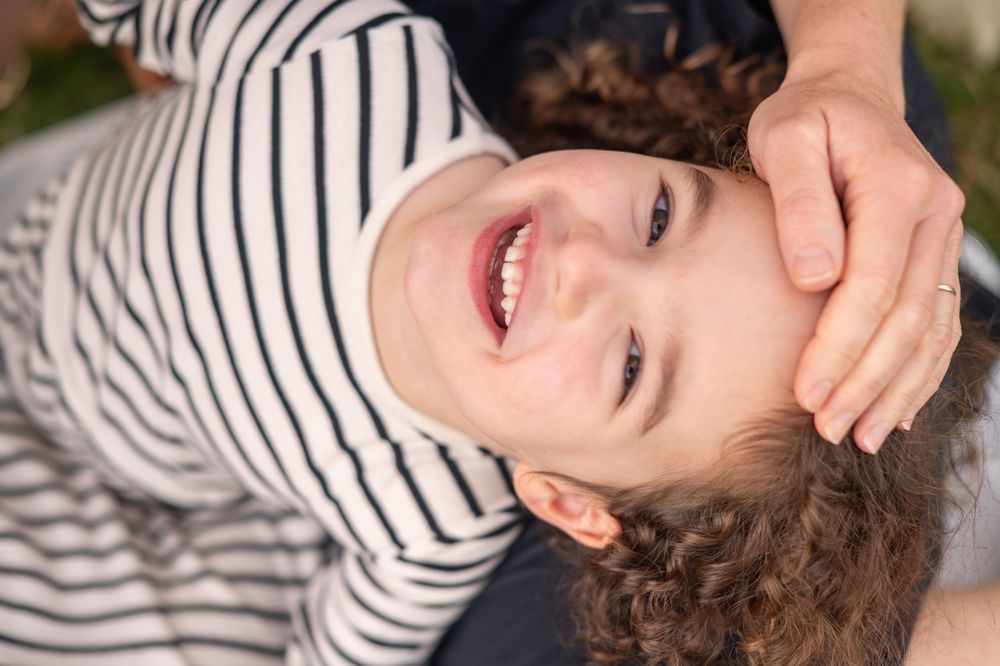 A series of close-up shots showing joyful expressions and playful moments in natural outdoor lighting.