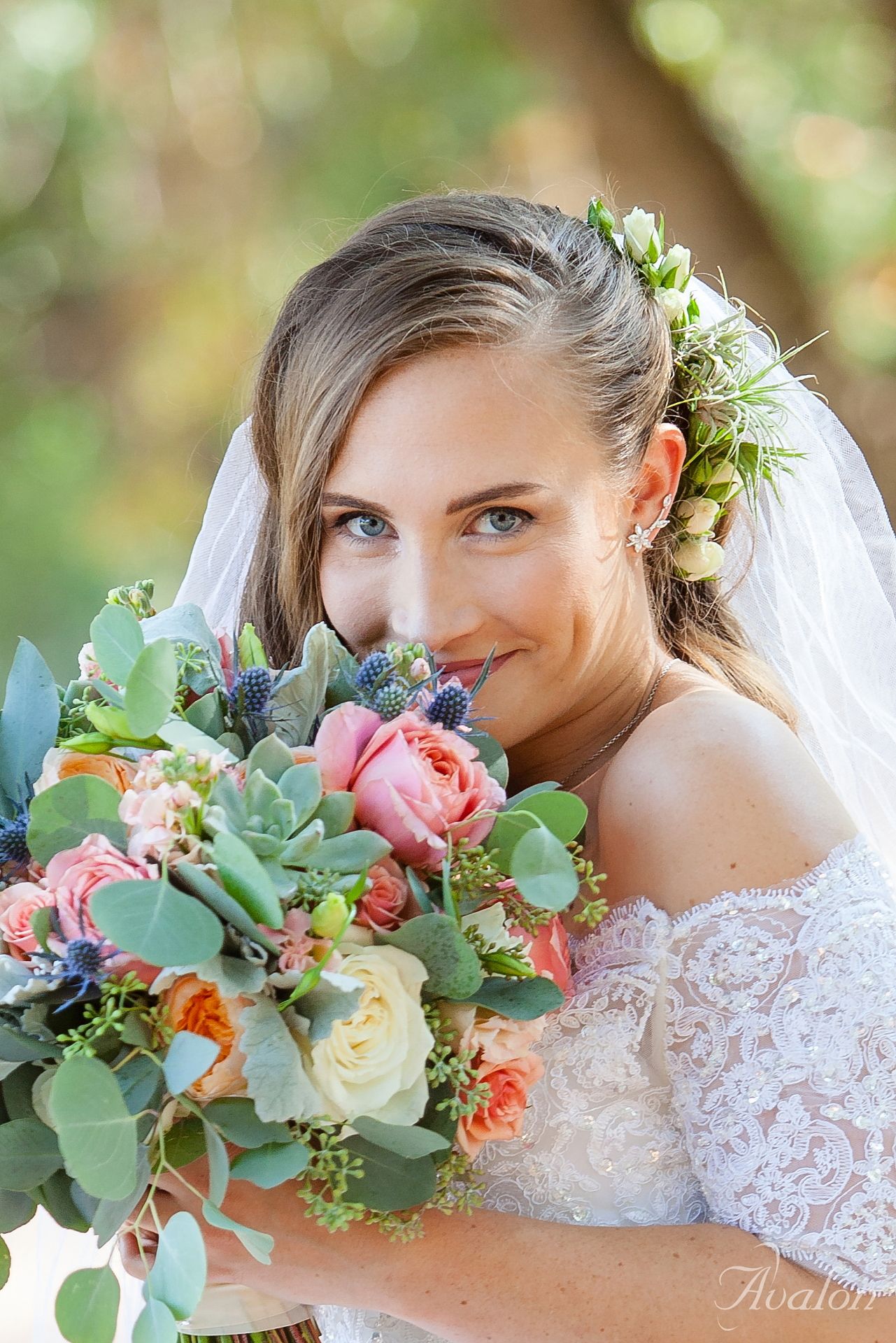 Close-up portrait showcasing a stunning bridal bouquet with pink roses and eucalyptus.
