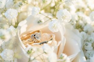 Diamond engagement ring nestled in delicate white flowers and baby's breath.