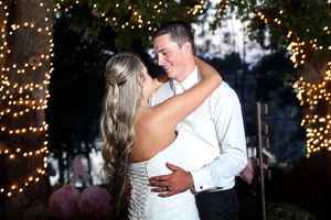 Romantic evening dance with twinkle lights creating magical wedding ambiance.