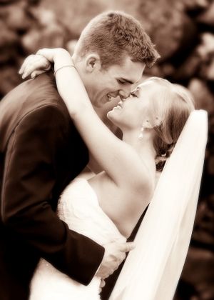 Romantic sepia-toned portrait of couple sharing an intimate moment.