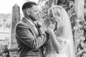 Couple shares romantic moment during outdoor wedding ceremony.