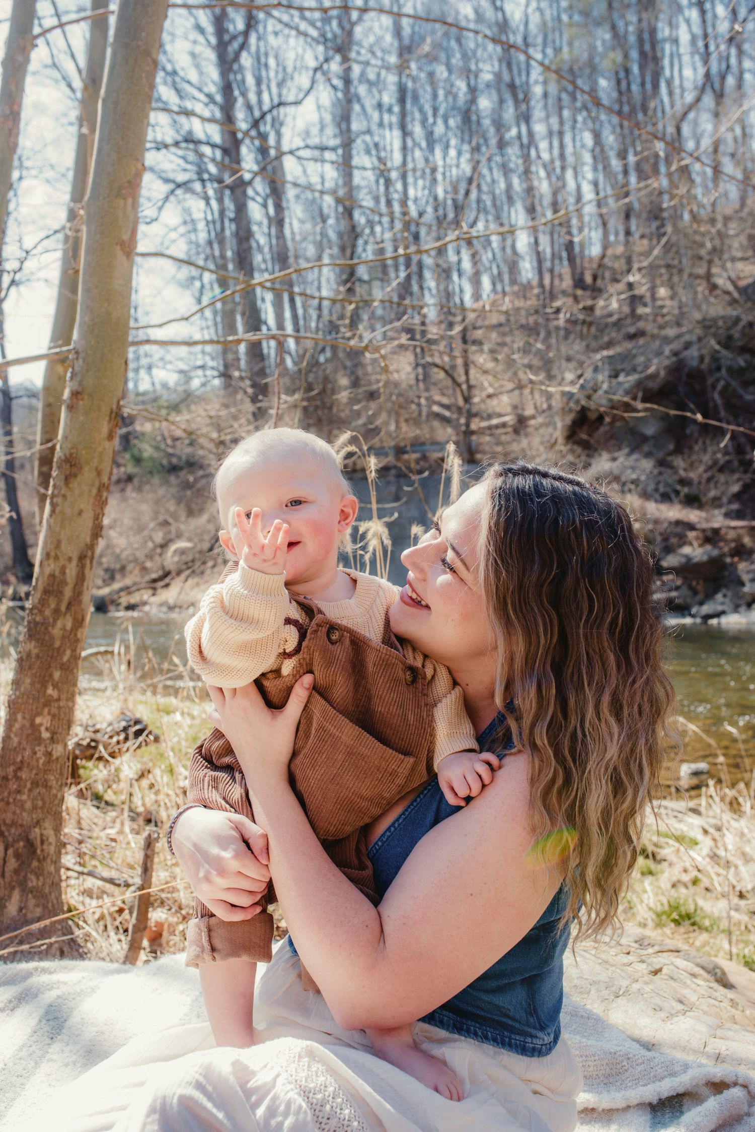 Family enjoying playful moments in spring forest setting.