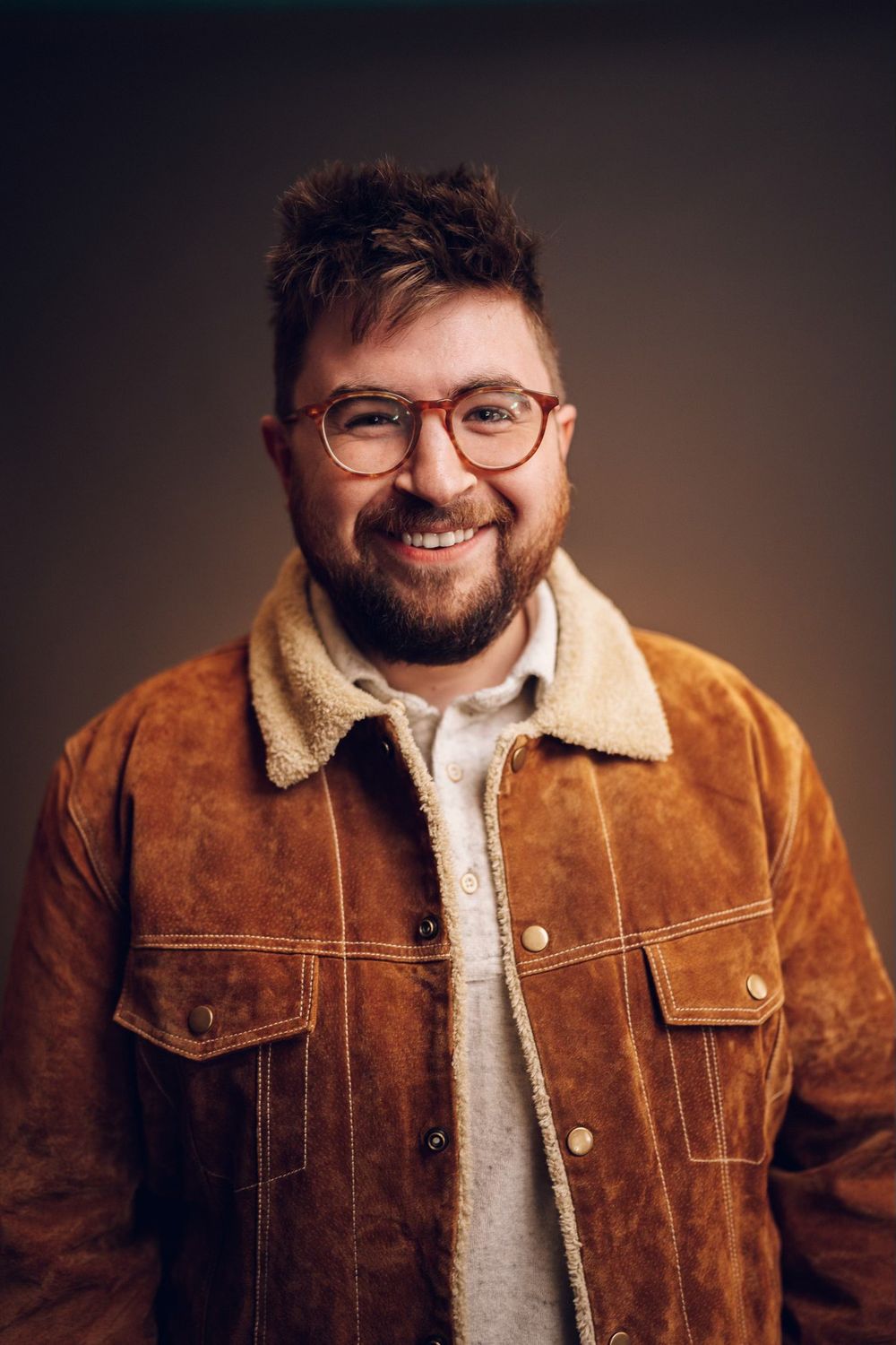 Portrait series showing person in brown suede jacket smiling against dark backdrop.