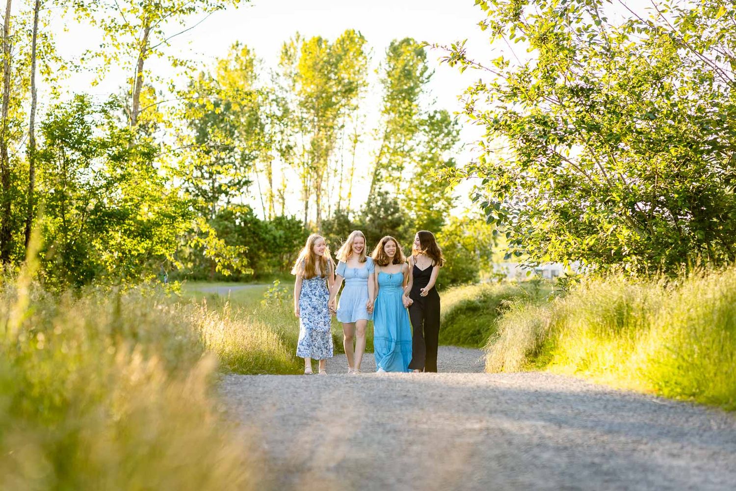Sisters smile and walk together at the Union Bay Natural Area trail.