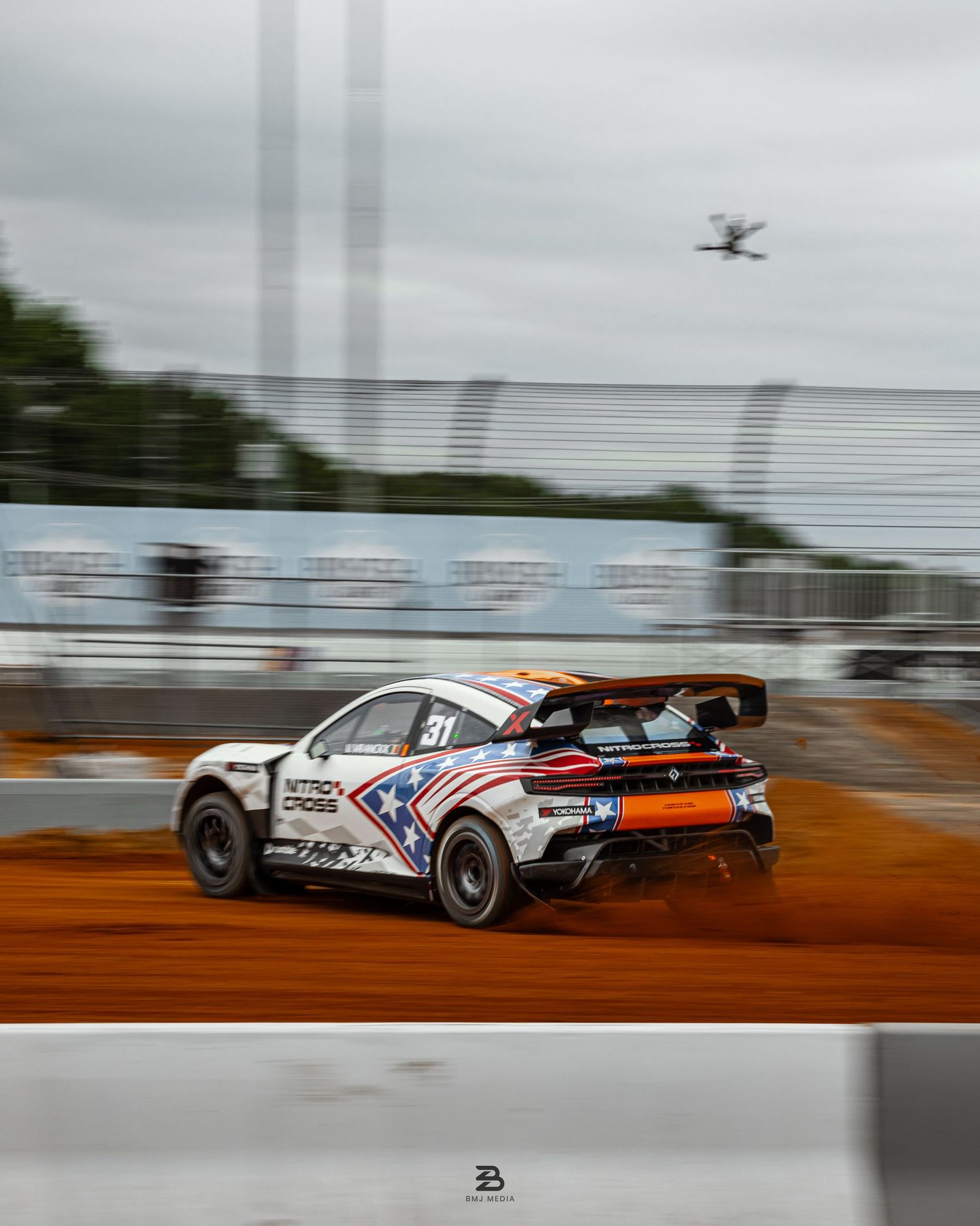 White Dodge Hornet drifting in dirt with drone camera following