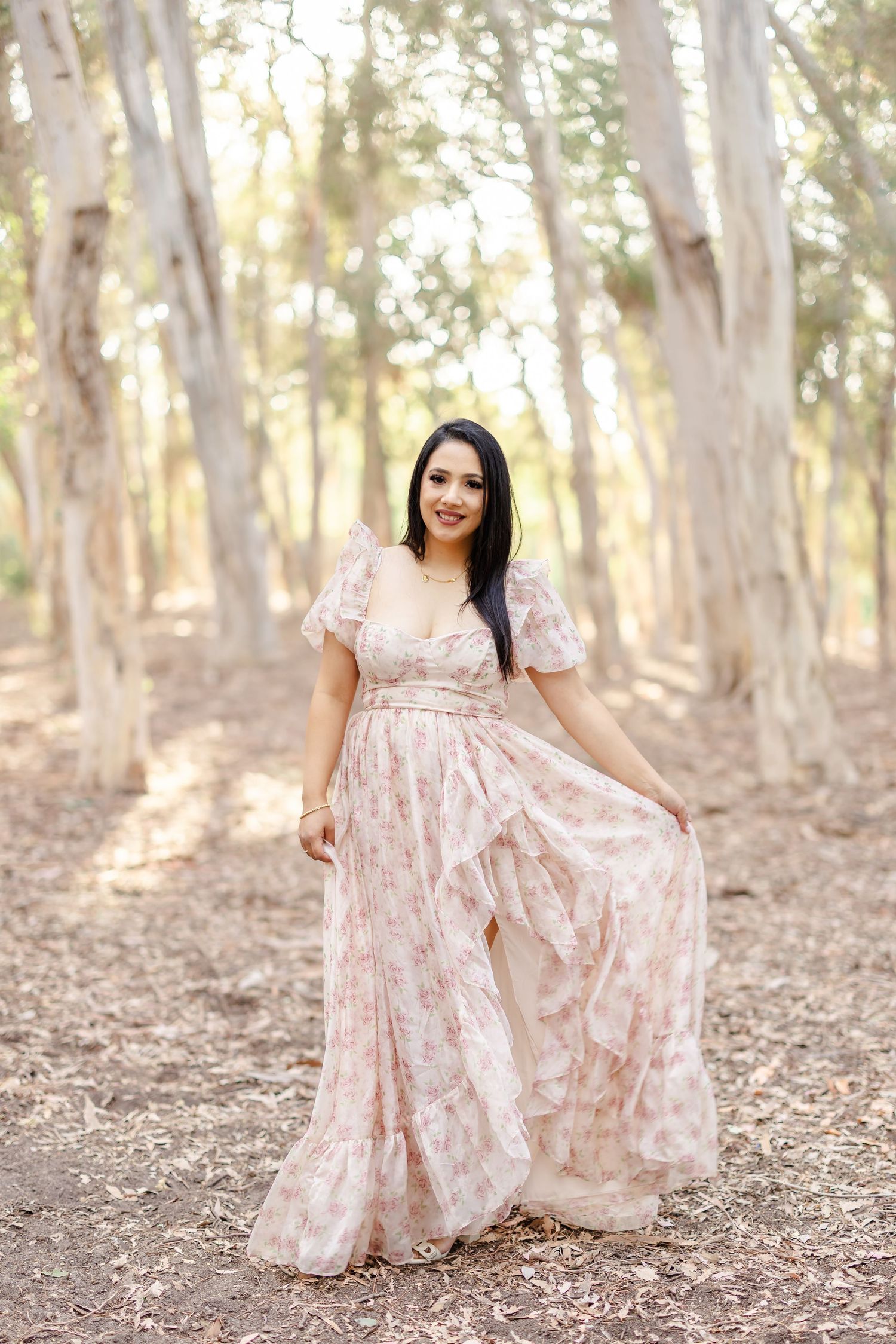 Someone in a white lace dress sits gracefully in a sunlit field of golden wheat at sunset.