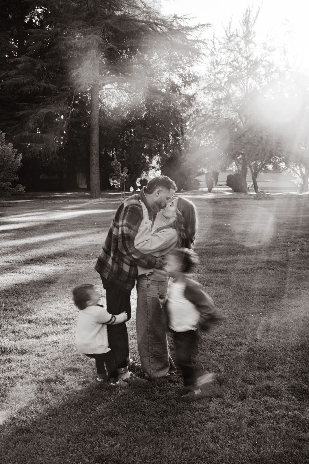 A sequence of black and white photos showing children playing in a misty park on a grassy field.